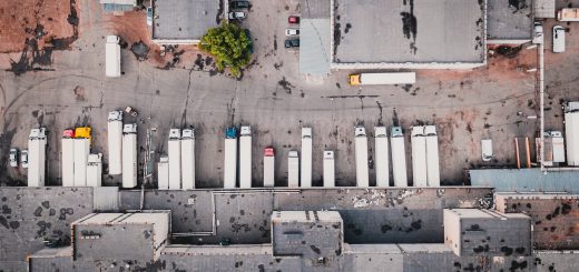 aerial view of trucks on gray commercial building during daytime photo, Photo by Ivan Bandura on Unsplash