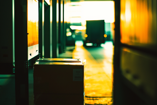 Package in warehouse with truck in distance