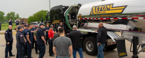 Positive Outlook: NTTC Tank Truck Week 2025 Celebrates 80 Years of Game-Changing Progress 3 Altom Transport conducts a hands-on tanker safety walkthrough with first responders around a stainless chemical trailer.
