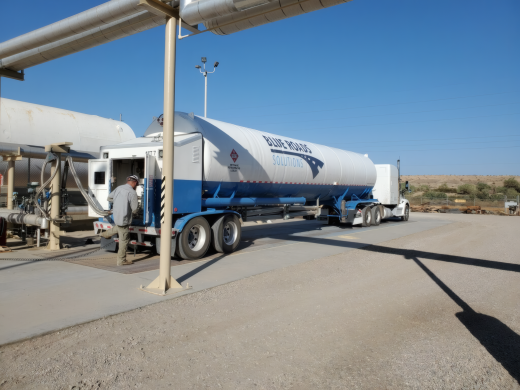Tanker truck beside an LNG processing tower and equipment at the Desert Gas plant in Ehrenberg, Arizona.