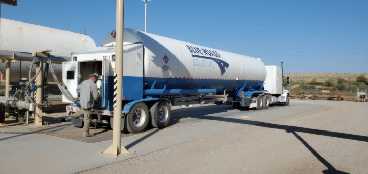 Tanker truck beside an LNG processing tower and equipment at the Desert Gas plant in Ehrenberg, Arizona.