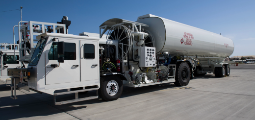 White Stephens aircraft refueler with exposed pumping equipment, hose reels and a large fuel tank at Edwards Air Force Base.
