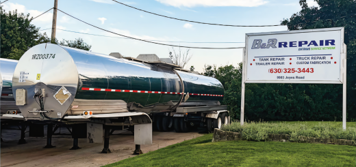 Polished tank trailer parked beside a B&R Repair sign displaying EnTrans Service Network branding.